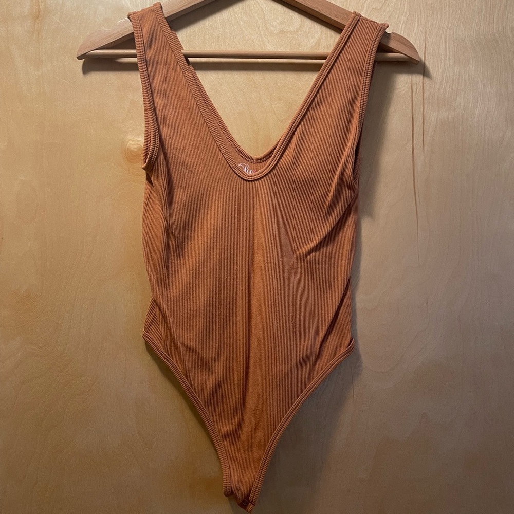 Worn one time, light nude/orange body suit.